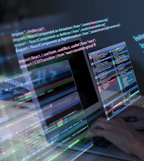 Na imagem, uma tela de computador com códigos de programação e mãos digitando no teclado. 